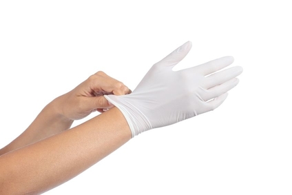 A person putting on latex gloves